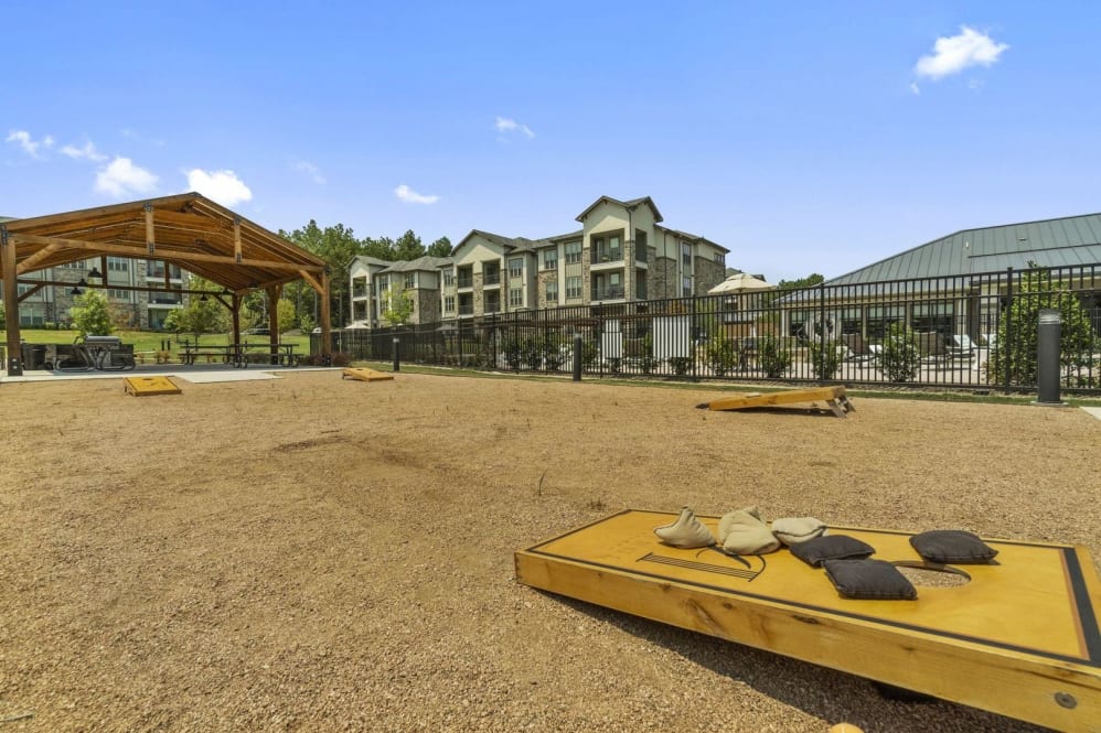 a large outdoor area with a sand pit and a building in the background at The Auberge of Tyler