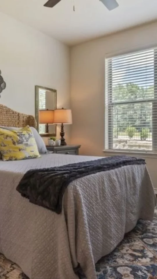 a bedroom with a large bed and a ceiling fan at The Auberge of Tyler