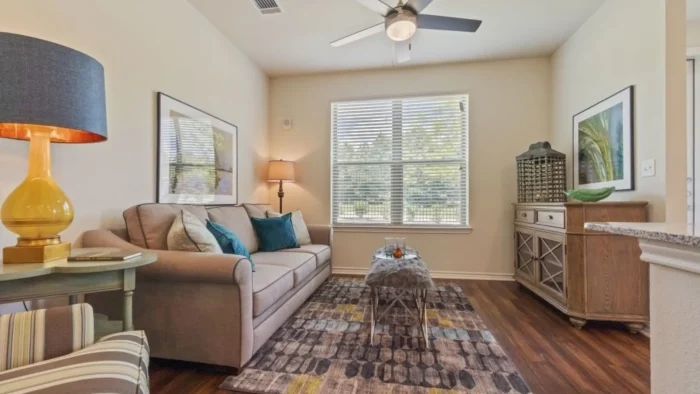 a living room with a ceiling fan and hardwood floors at The Auberge of Tyler