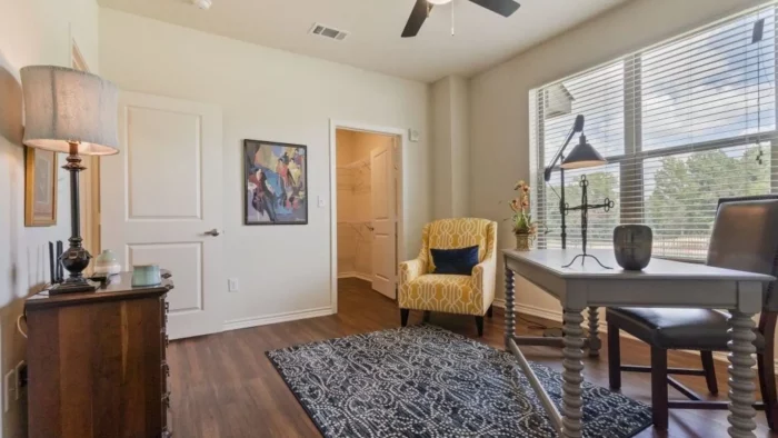 a living room with a ceiling fan and hardwood floors at The Auberge of Tyler