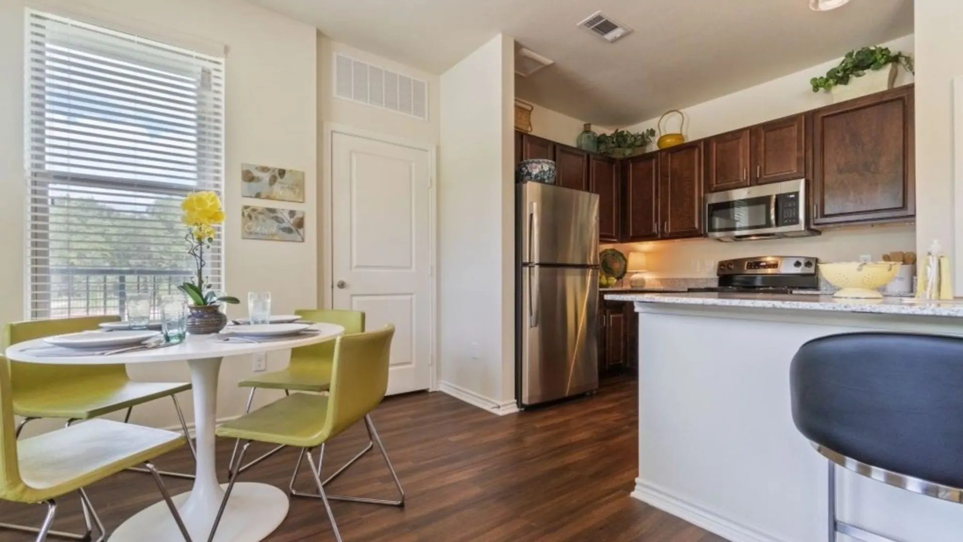 kitchen with wood floors and stainless steel appliances at The Auberge of Tyler