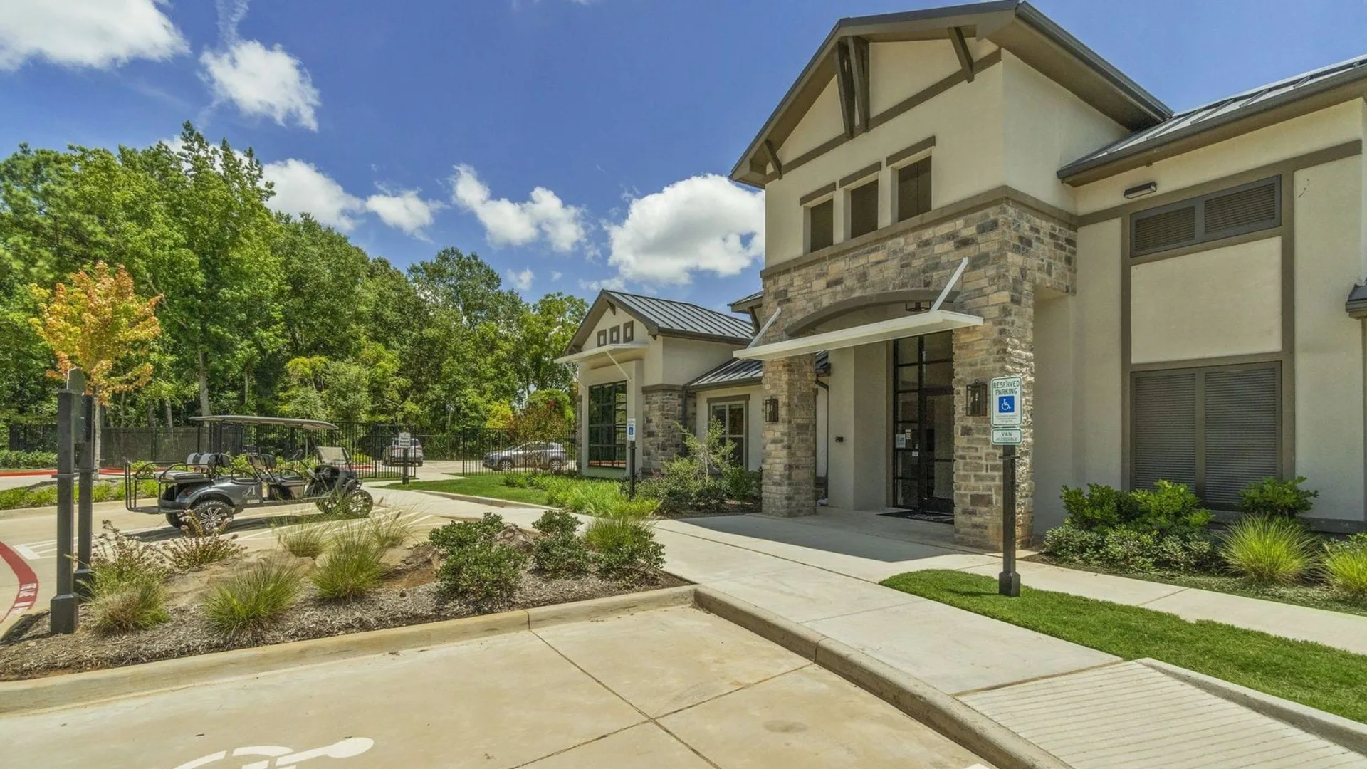 the front entrance to a residential community with a parking lot at The Auberge of Tyler